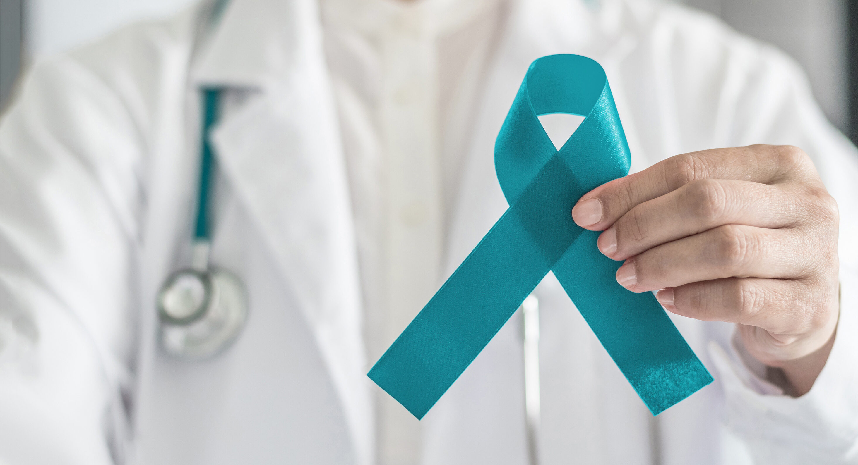 Doctor holds teal ribbon in support of PCOS Awareness Month | Reproductive Science Center of New Jersey | Eatontown